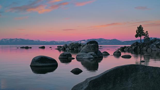 Solid rocks in dawn by macOS Tahoe · Wallpapery